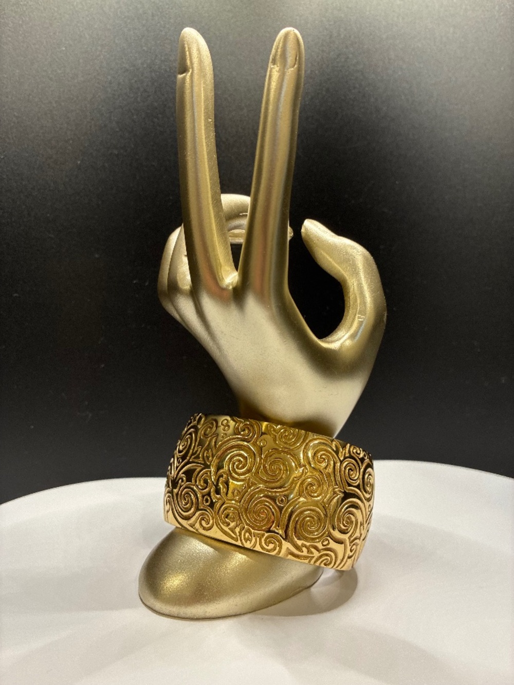 Vintage designer stamped gold-tone hammered metal cuff with swirled motif